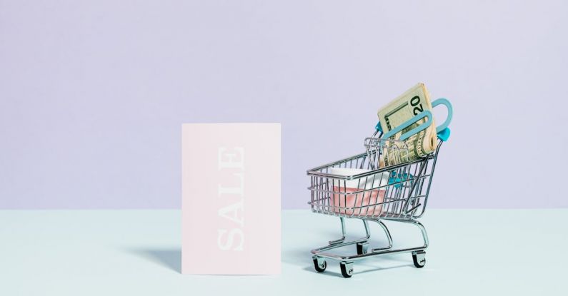 Savings Cart - Sale Sign Beside A Miniature Shopping Cart