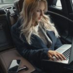 Travel Gadgets - Woman in Blue Coat Sitting on Car Seat