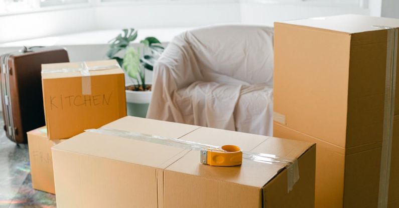 Carry-on Luggage - Empty apartment with packed carton boxes before moving