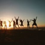 Eco-friendly Travel - Silhouette Photography of Group of People Jumping during Golden Time