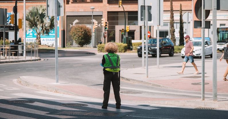 Adapter Guide - A person standing on a street corner with a green jacket