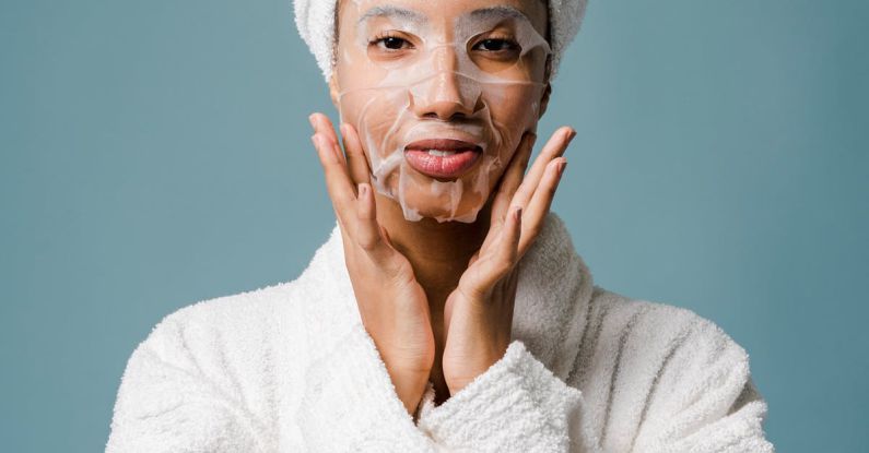 Recovery Essentials - Black woman after spa applying sheet mask