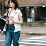 Pet Carrier - Woman with pet carrier and coffee to go crossing road