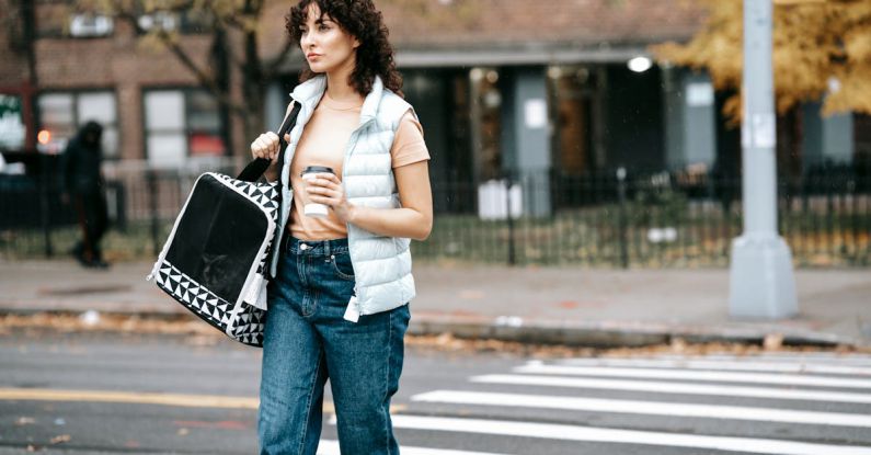 Pet Carrier - Woman with pet carrier and coffee to go crossing road