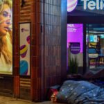 Boutique Stores - Person Sleeping In Pavement Near Glass Window