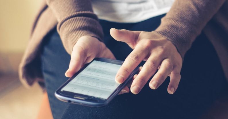 Personal Information - Person Holding Smartphone While Sitting