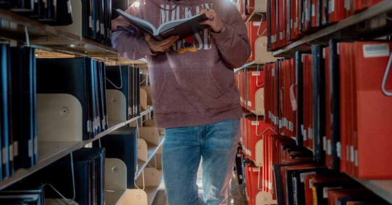 Student Discounts - Man Reading Book In Library