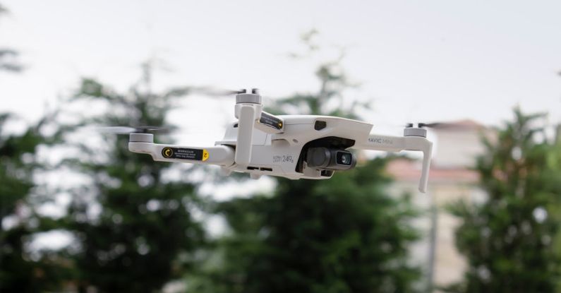 Drone Flying - A white drone flying over a city street