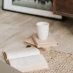 Eco Gadgets - Laptop and books on floor carpet