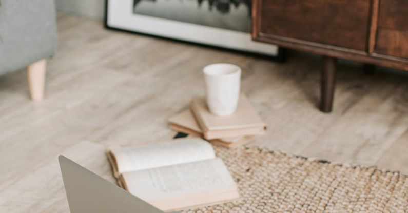 Eco Gadgets - Laptop and books on floor carpet