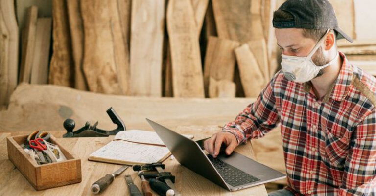 Remote Work - Man Using a Laptop at a Wood Workshop