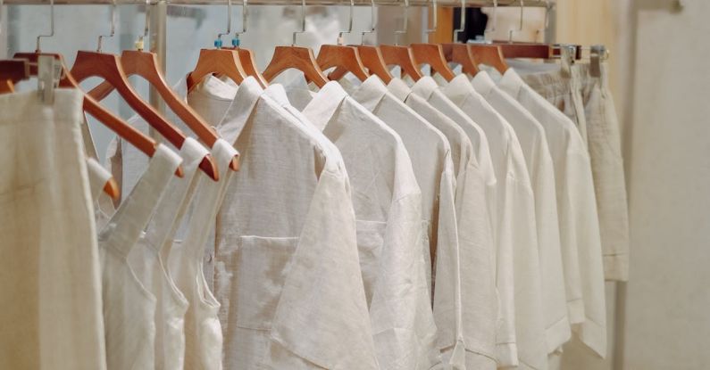 Capsule Wardrobe - Clothes in Neutral Colors Hanging on the Racks in a Clothing Store