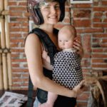 Baby Gear - Woman Wearing Brown Helmet While Carrying Her Baby