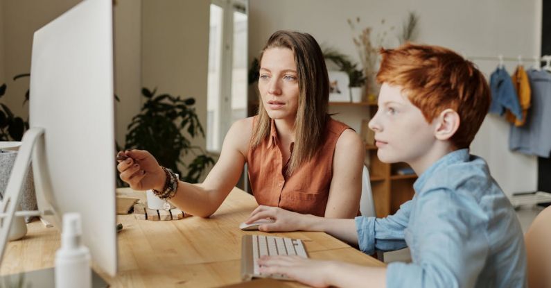 Smart Parenting - Photo Of Woman Tutoring Young Boy